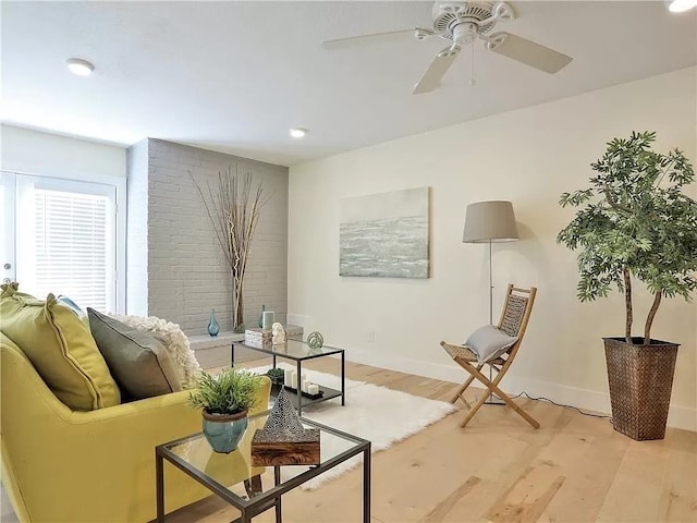 living room featuring ceiling fan and light wood-type flooring