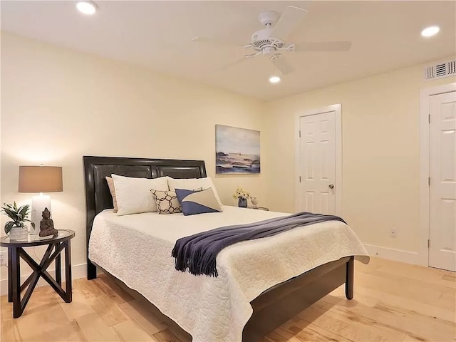 bedroom with ceiling fan and light wood-type flooring