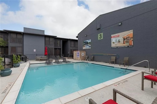 view of swimming pool with a patio