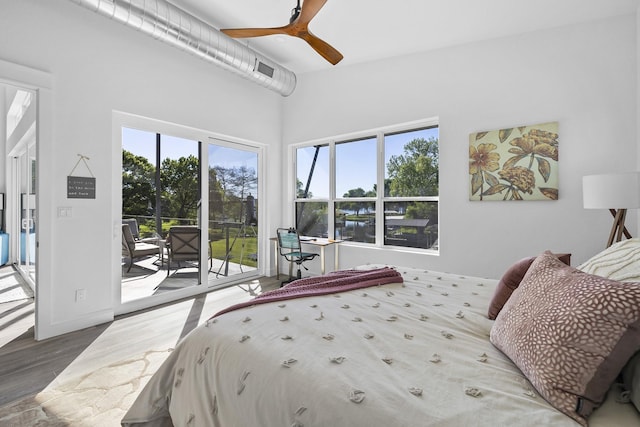 bedroom with ceiling fan, access to exterior, and hardwood / wood-style flooring