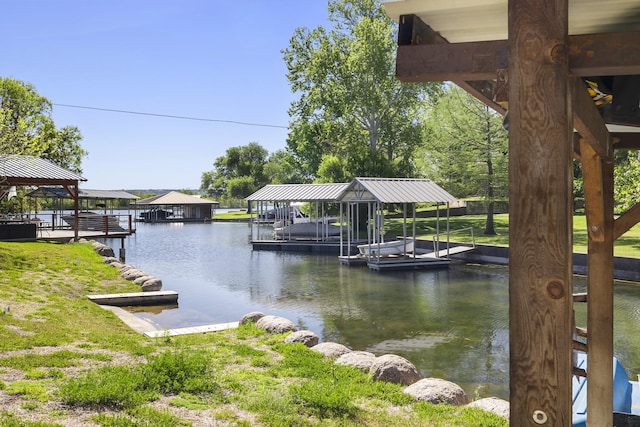 view of dock with a lawn and a water view