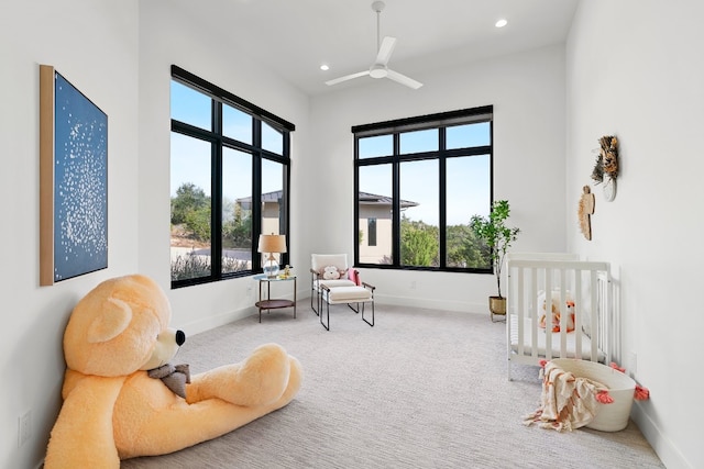 living area featuring ceiling fan and carpet floors