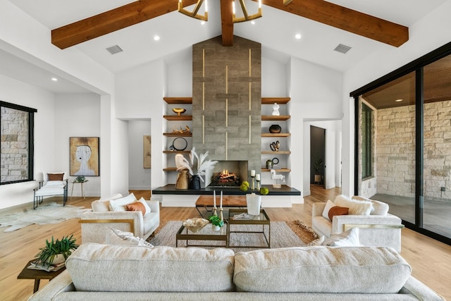 living room featuring beamed ceiling, high vaulted ceiling, light hardwood / wood-style flooring, and a fireplace