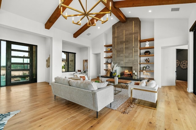 living room featuring beamed ceiling, high vaulted ceiling, and light hardwood / wood-style floors