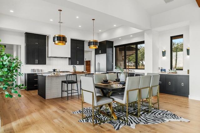 dining space featuring light wood-type flooring