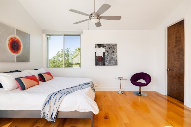 bedroom featuring hardwood / wood-style floors, ceiling fan, and lofted ceiling