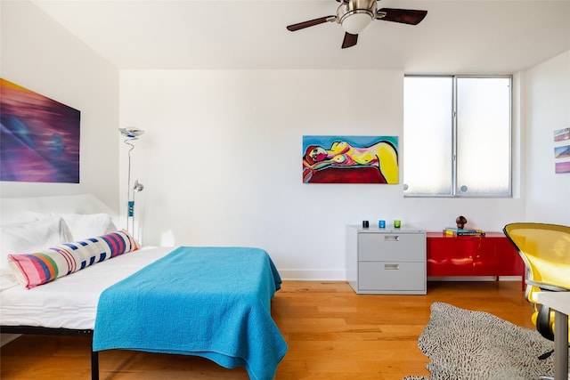 bedroom with ceiling fan and light wood-type flooring