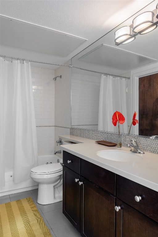 full bathroom featuring toilet, vanity, tile patterned floors, and shower / tub combo with curtain