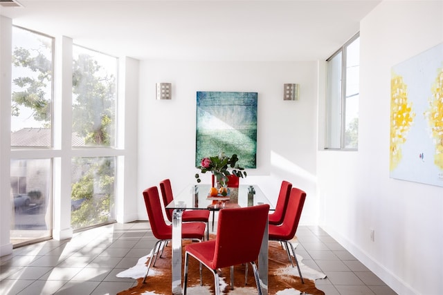 tiled dining space with floor to ceiling windows and a healthy amount of sunlight