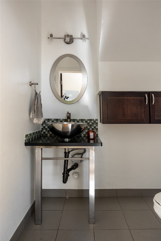 bathroom featuring tile patterned floors, vanity, and toilet