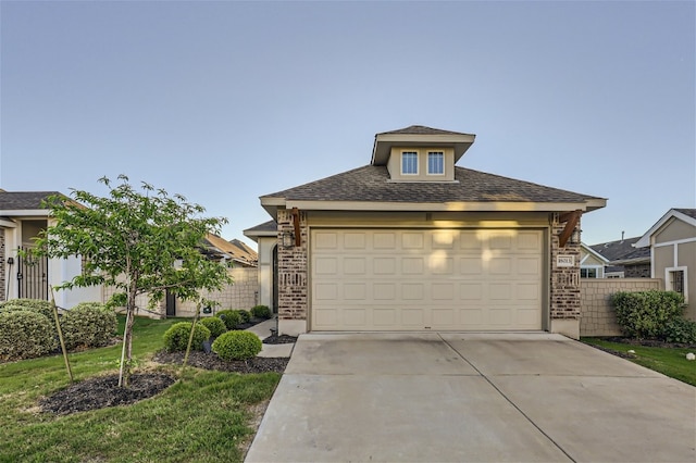 view of front of property featuring a front lawn and a garage