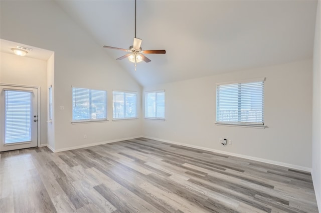 unfurnished room with light hardwood / wood-style floors, ceiling fan, high vaulted ceiling, and a wealth of natural light