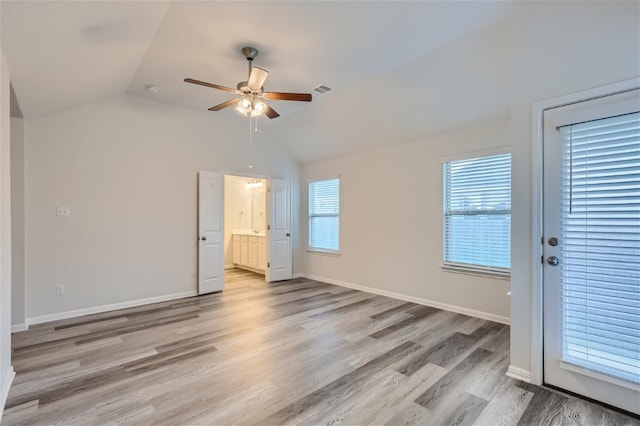 unfurnished room featuring light hardwood / wood-style floors, ceiling fan, and vaulted ceiling