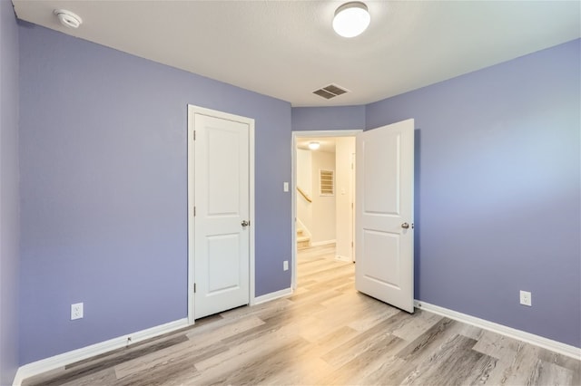 unfurnished bedroom with light wood-type flooring