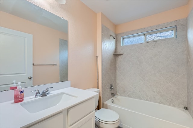 full bathroom featuring tiled shower / bath, toilet, and vanity