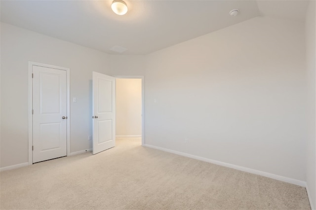 unfurnished bedroom with lofted ceiling and light carpet