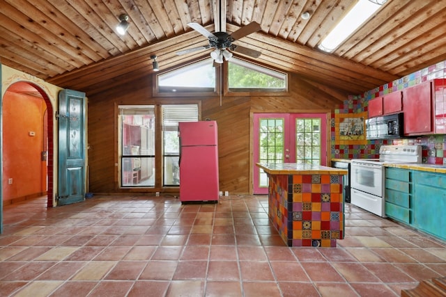 kitchen with white appliances, tile counters, light tile floors, and wooden ceiling