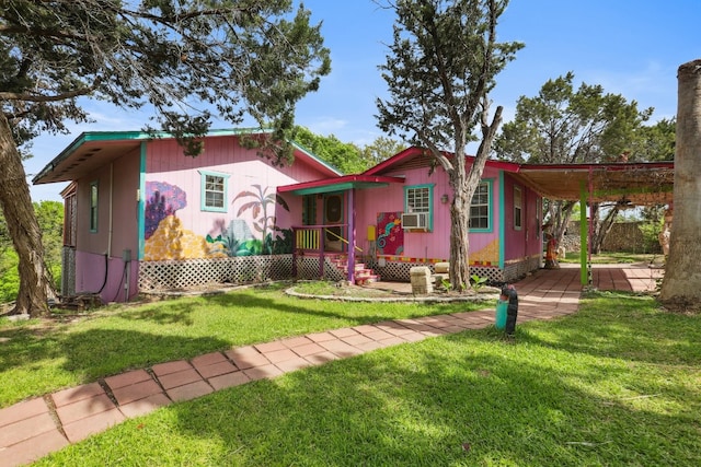 view of front of house with a front lawn and a carport