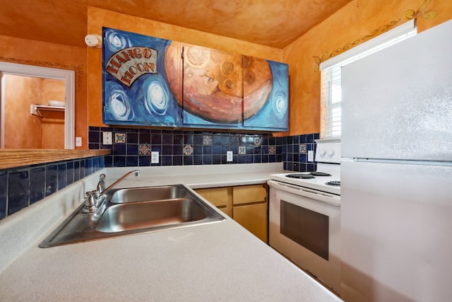 kitchen with white appliances, tasteful backsplash, and sink