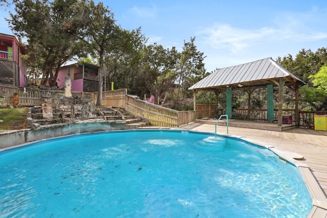 view of swimming pool with a gazebo and a wooden deck