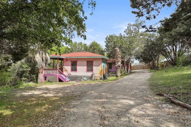 exterior space with a wooden deck and a front lawn