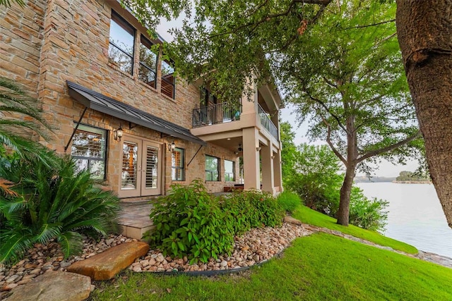 view of front facade featuring french doors and a balcony