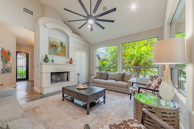 living room with ceiling fan, light tile patterned flooring, and high vaulted ceiling