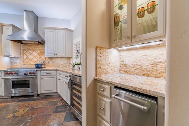 kitchen featuring appliances with stainless steel finishes, wall chimney exhaust hood, backsplash, wine cooler, and dark tile patterned flooring