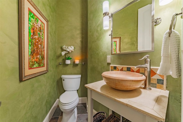 bathroom featuring vanity, tile patterned flooring, and toilet