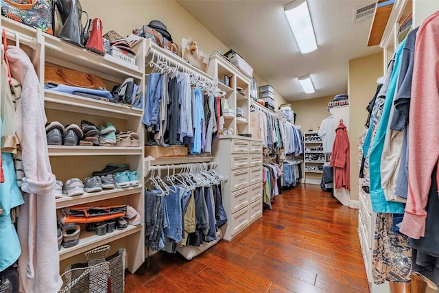 spacious closet featuring dark wood-type flooring