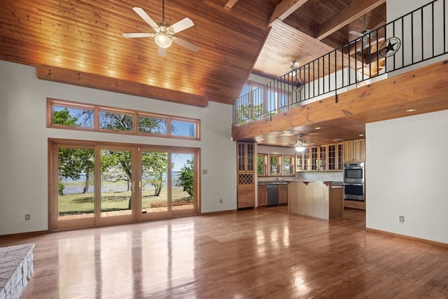 unfurnished living room with wooden ceiling, ceiling fan, light wood-type flooring, and a high ceiling