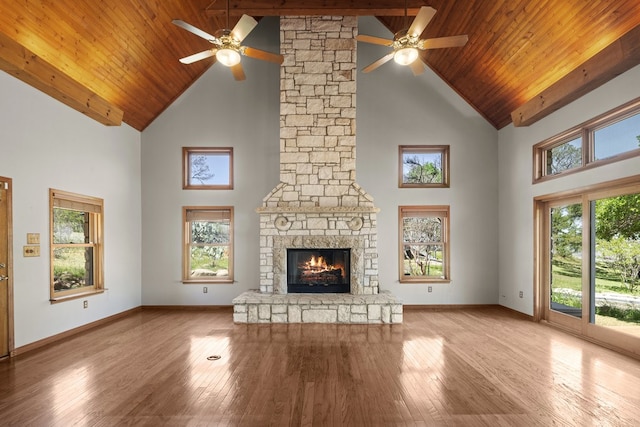 unfurnished living room with high vaulted ceiling, a healthy amount of sunlight, and ceiling fan