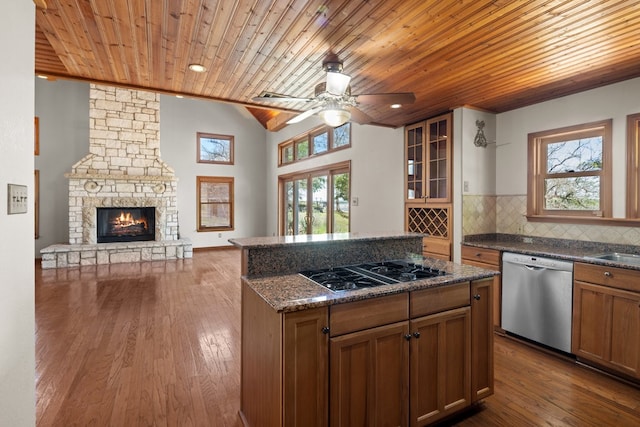 kitchen with dark hardwood / wood-style flooring, tasteful backsplash, stainless steel dishwasher, ceiling fan, and wood ceiling