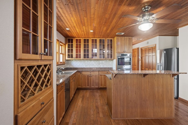 kitchen featuring a kitchen breakfast bar, wood ceiling, and dark hardwood / wood-style floors