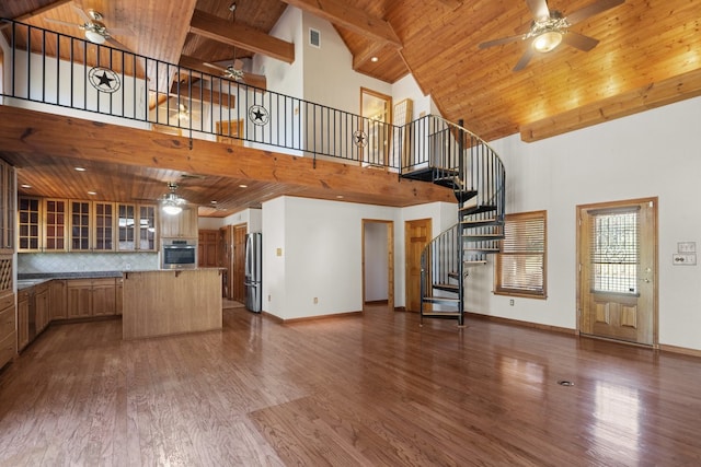 unfurnished living room with high vaulted ceiling, dark hardwood / wood-style flooring, wooden ceiling, and ceiling fan