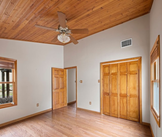 unfurnished bedroom with light hardwood / wood-style flooring, ceiling fan, high vaulted ceiling, and wooden ceiling