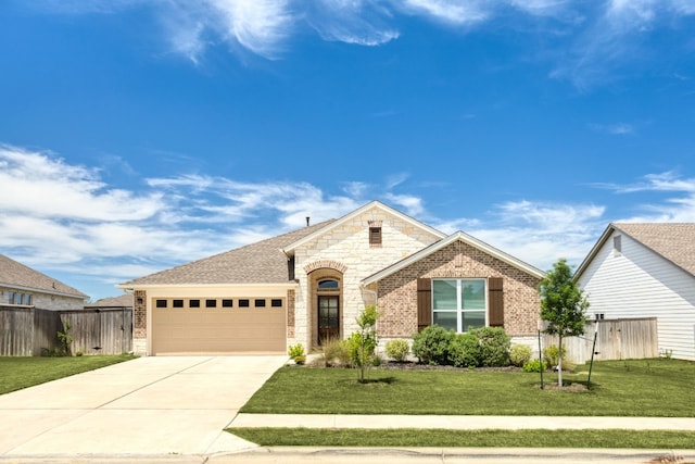 view of front of property with a front yard and a garage