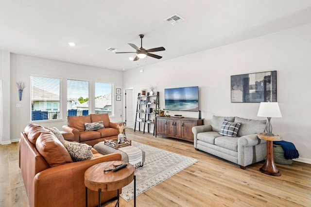 living room featuring ceiling fan and light hardwood / wood-style floors