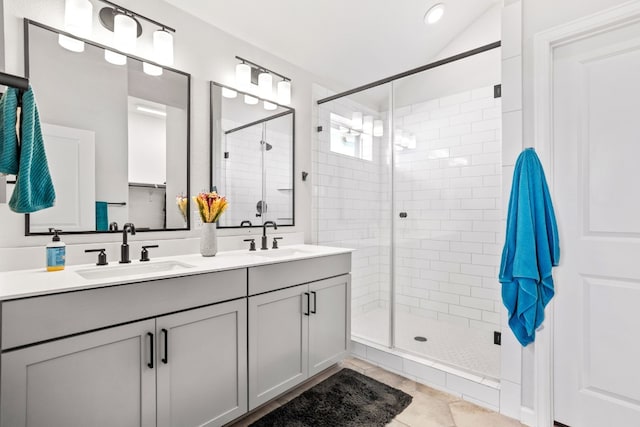 bathroom with tile flooring, dual sinks, an enclosed shower, and oversized vanity