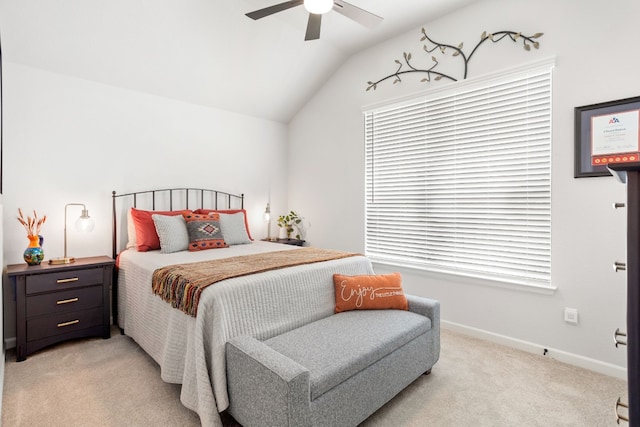 carpeted bedroom with ceiling fan and vaulted ceiling