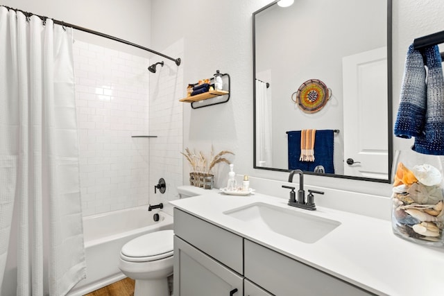 full bathroom with hardwood / wood-style flooring, oversized vanity, shower / bath combination with curtain, and toilet