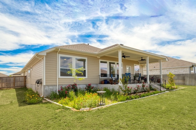 rear view of property with a patio, ceiling fan, and a lawn