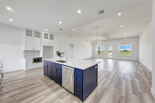 kitchen with sink, stainless steel appliances, blue cabinets, decorative backsplash, and white cabinets