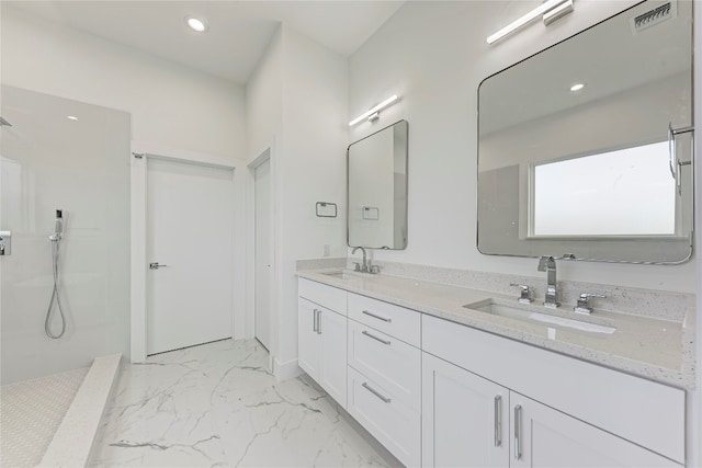 bathroom with a shower and vanity