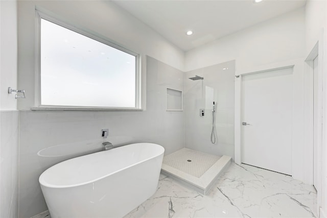 bathroom with plenty of natural light and independent shower and bath