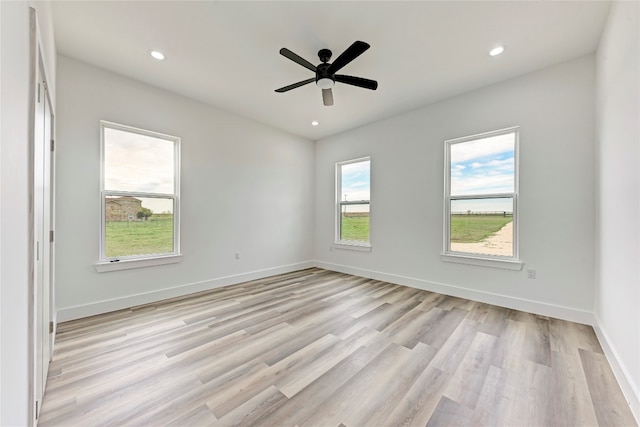 unfurnished room with ceiling fan and light hardwood / wood-style floors