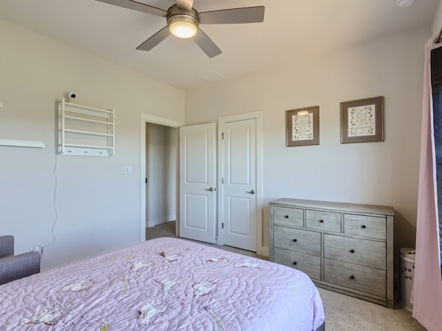 bedroom featuring ceiling fan and light carpet