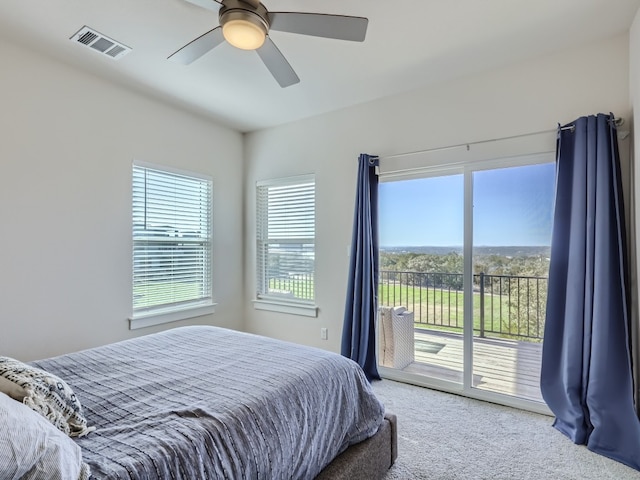 bedroom featuring access to exterior, ceiling fan, and light colored carpet