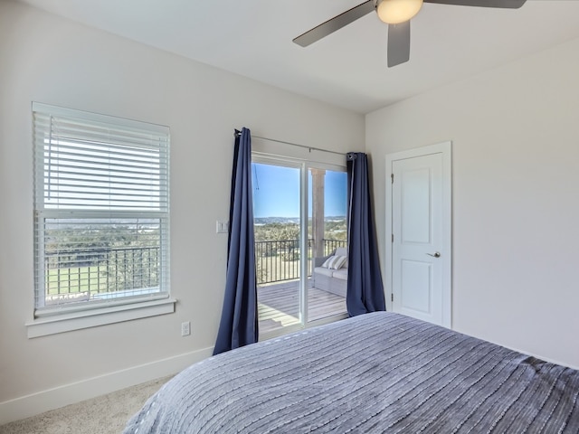 carpeted bedroom with ceiling fan, access to outside, and multiple windows