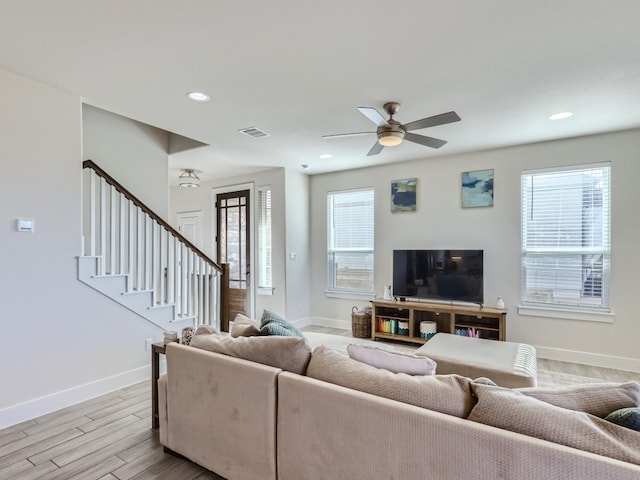 living room featuring ceiling fan and light hardwood / wood-style flooring